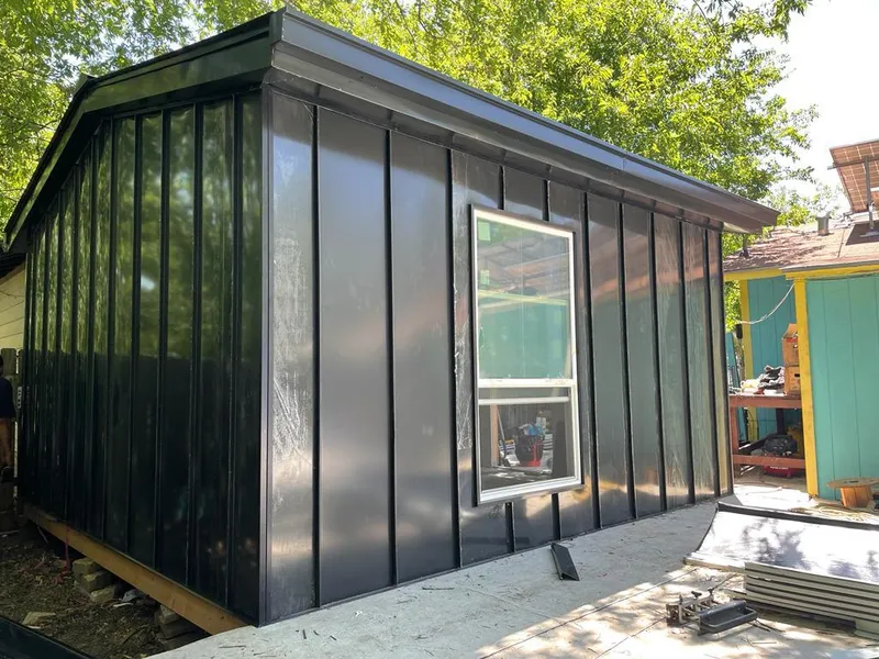 Black standing seam metal wall panels for Roof Inspection in Keller